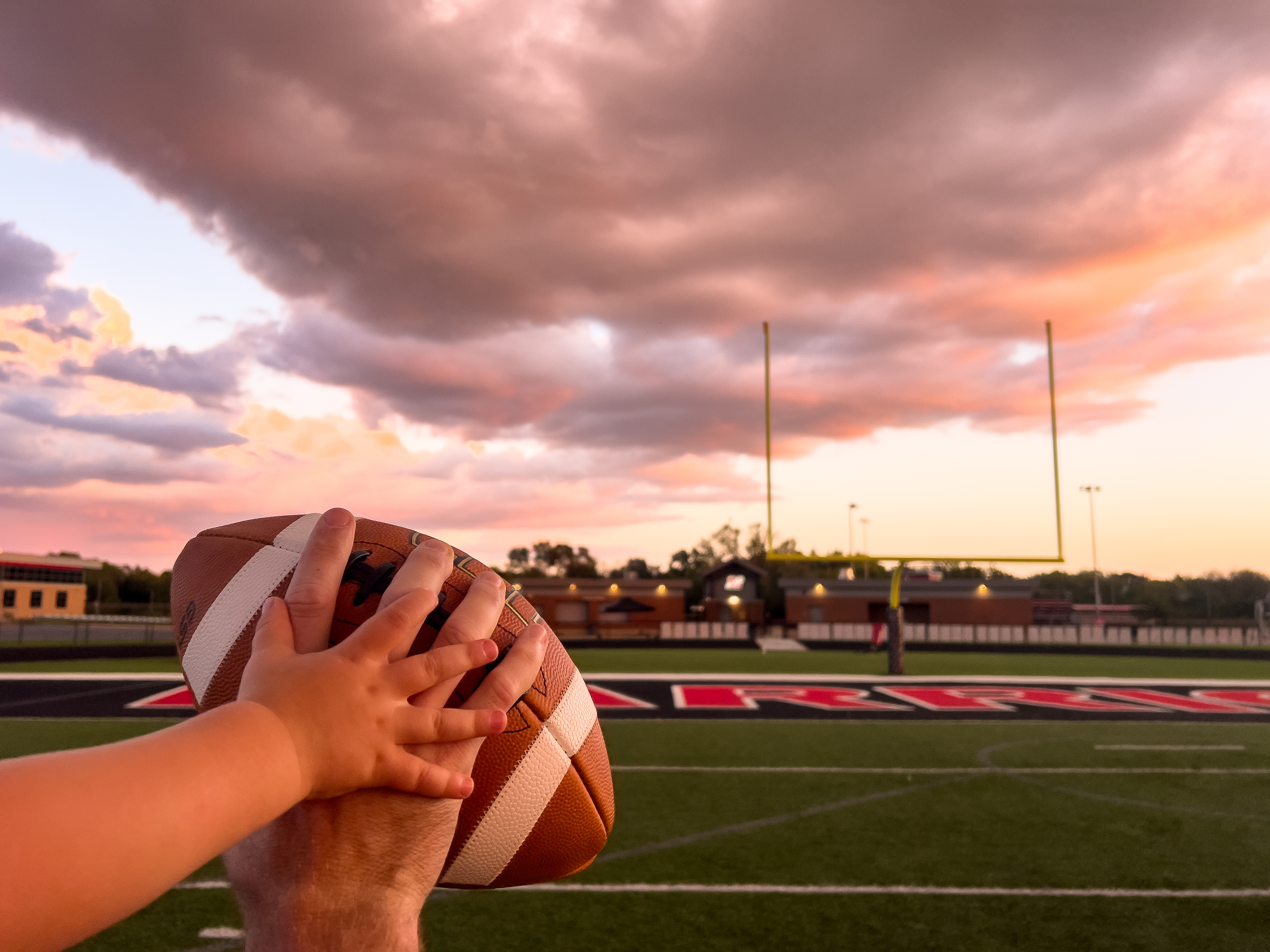 Coach on the field at sunset