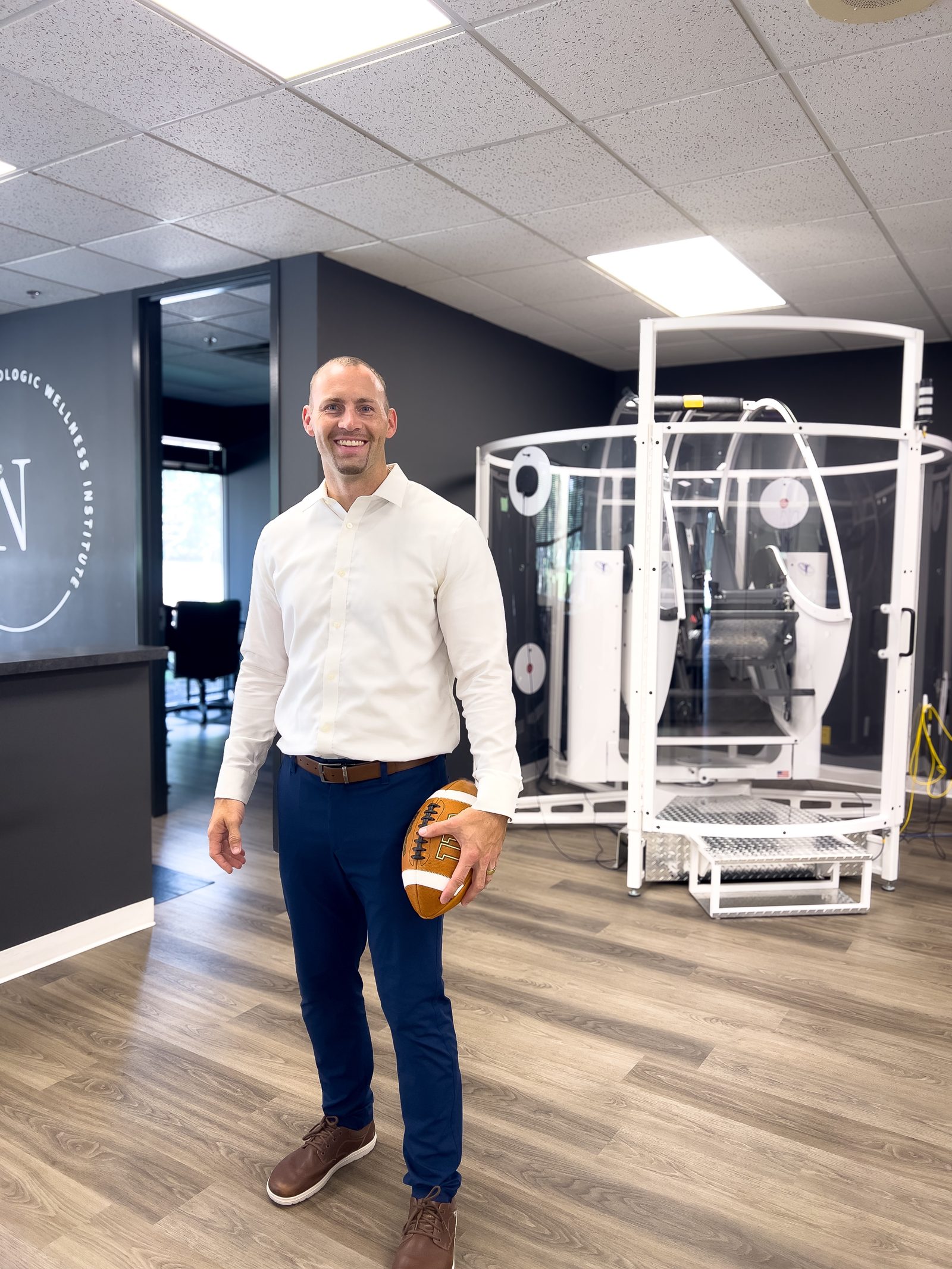 Dr. Nick holding a football in the clinic